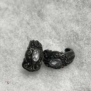 Curved design antiqued earrings with beautiful faceted cut stone.